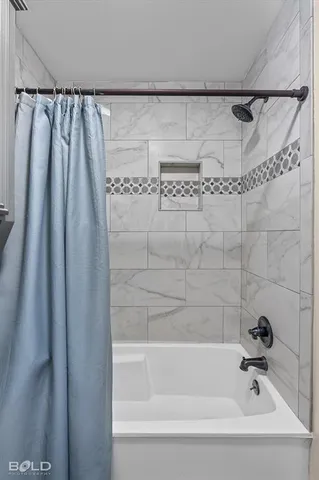 a bathroom with a shower and a bath tub