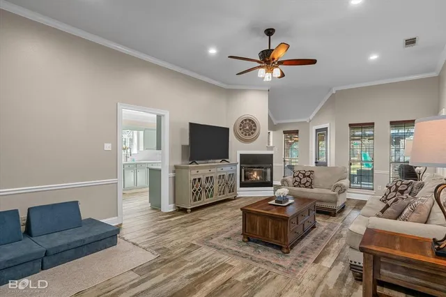 a living room with furniture a fireplace and a window