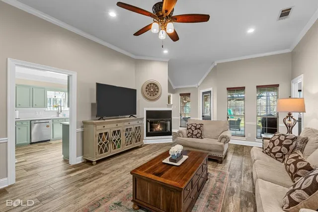 a living room with furniture a fireplace and a flat screen tv