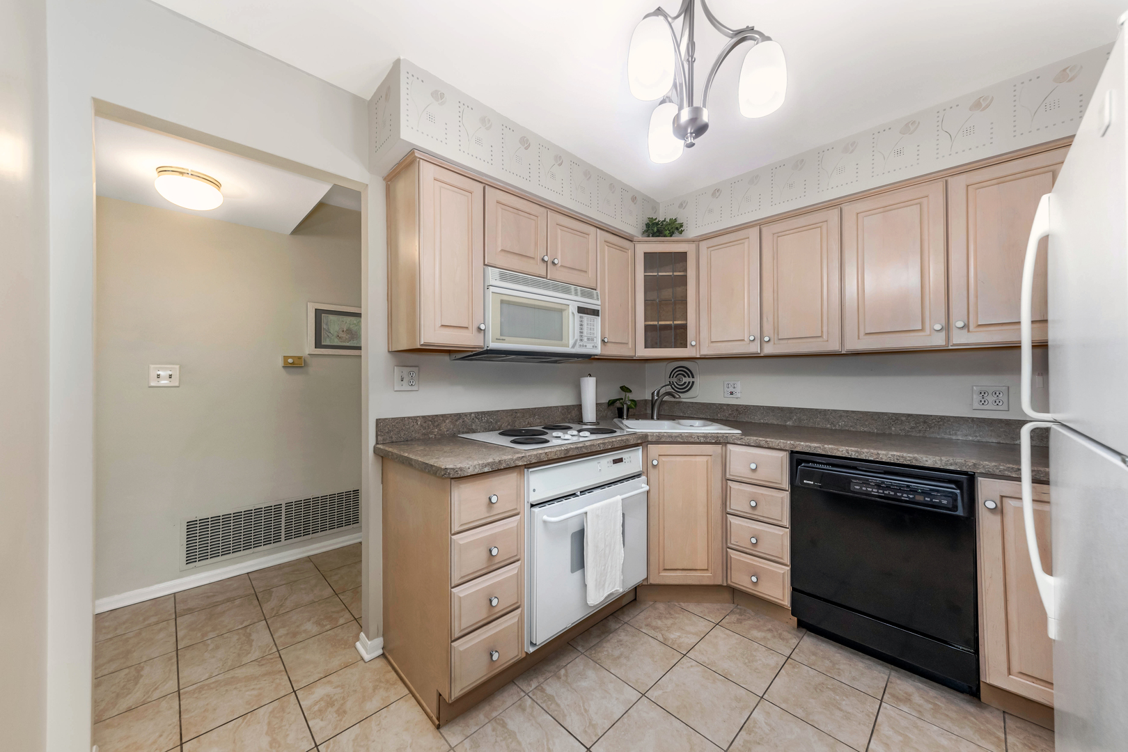 101 Bar Harbour Road, Unit 2G Schaumburg, IL 60193 - Photo 11 of 24 a kitchen with stainless steel appliances granite countertop a stove a sink and a microwave