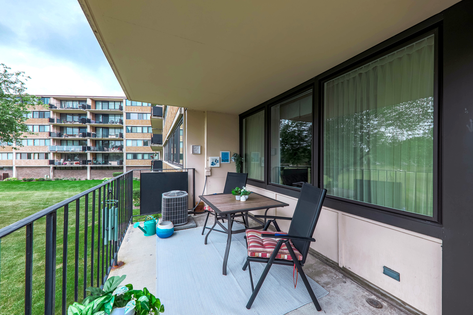 101 Bar Harbour Road, Unit 2G Schaumburg, IL 60193 - Photo 22 of 24 a view of a porch with furniture and garden