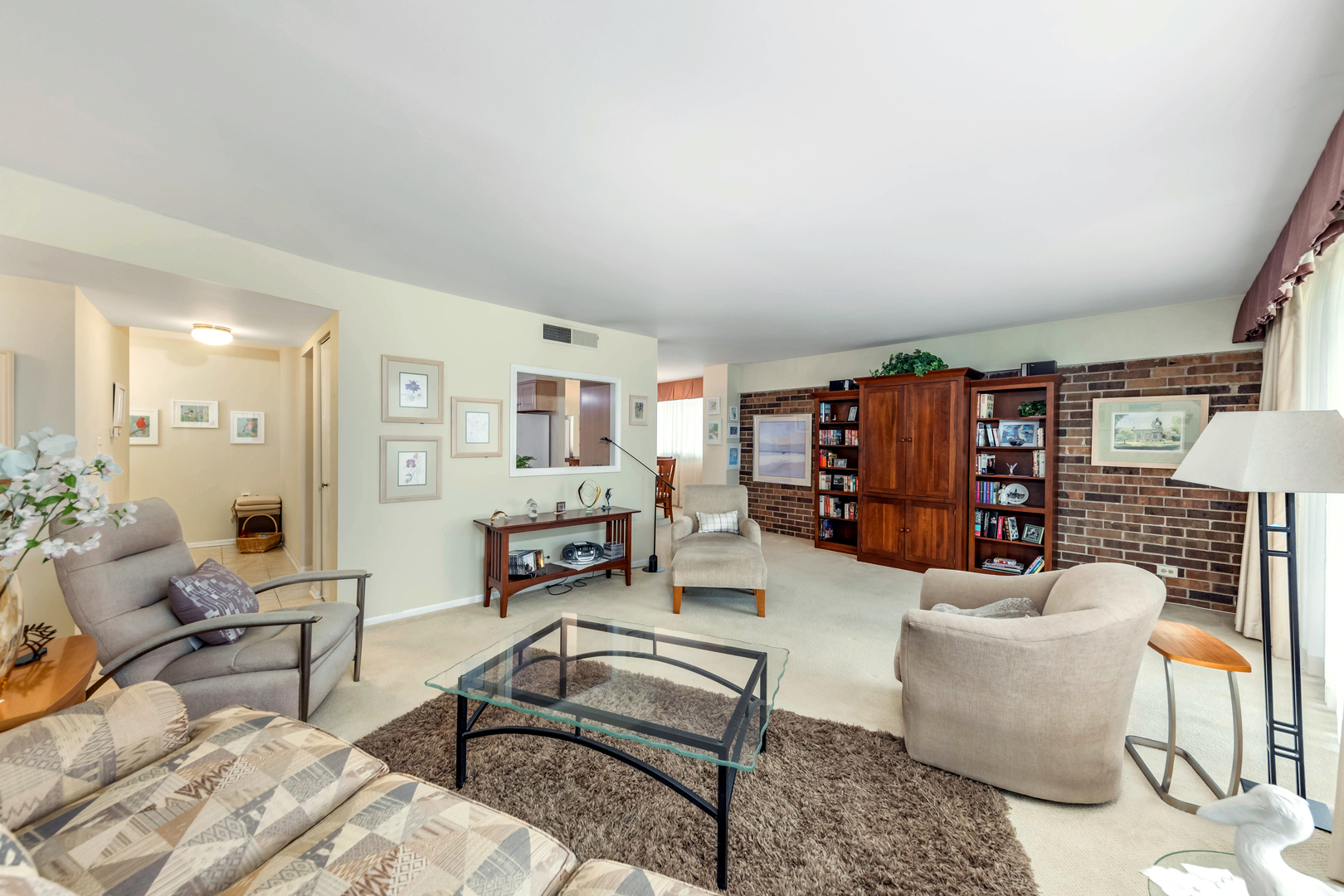 101 Bar Harbour Road, Unit 2G Schaumburg, IL 60193 - Photo 8 of 24 a living room with furniture or couch and a bookshelf