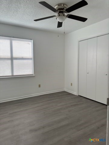 1815 Cedarhill Drive, Unit C Killeen, TX 76543 - Photo 17 of 27 an empty room with wooden floor fan and windows