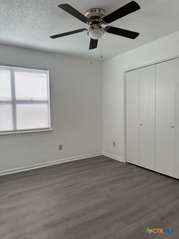 1815 Cedarhill Drive, Unit C Killeen, TX 76543 - Photo 19 of 27 a view of an empty room with wooden floor and a window