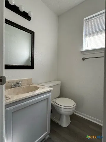 a bathroom with a toilet sink and mirror
