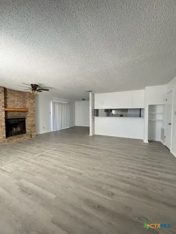 a view of empty room with a fireplace