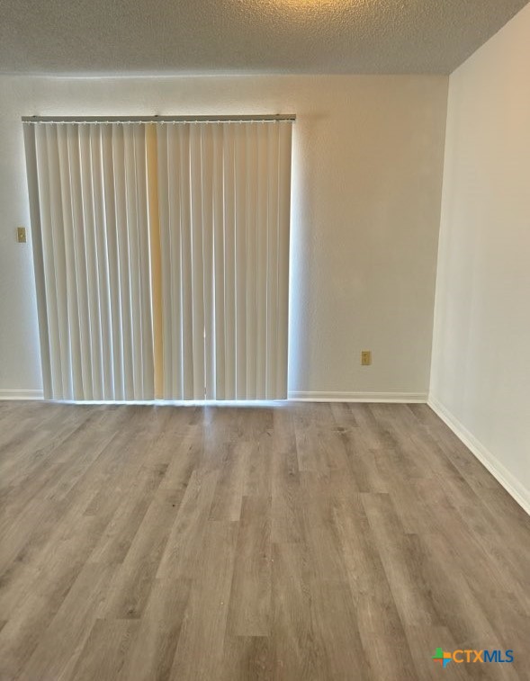 1815 Cedarhill Drive, Unit C Killeen, TX 76543 - Photo 8 of 27 an empty room with wooden floor