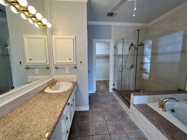 a bathroom with a granite countertop sink a toilet and shower