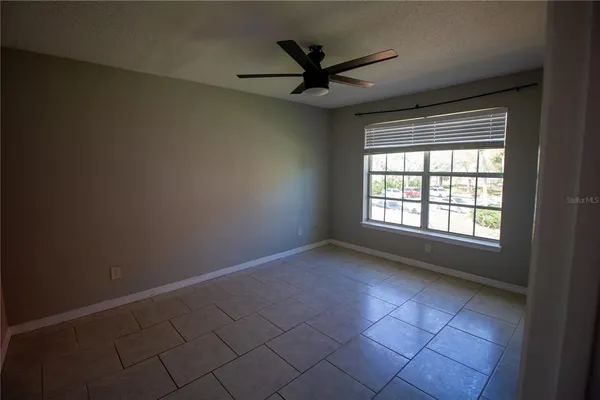 a view of a livingroom with a ceiling fan and window