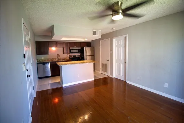 a view of a kitchen with a sink and a refrigerator