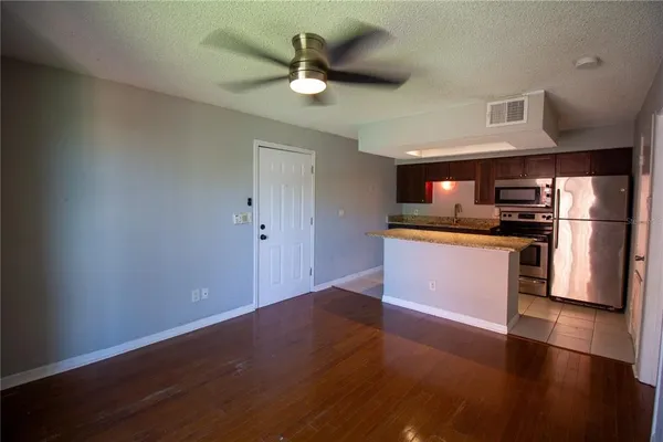 a kitchen with stainless steel appliances a refrigerator and a stove top oven