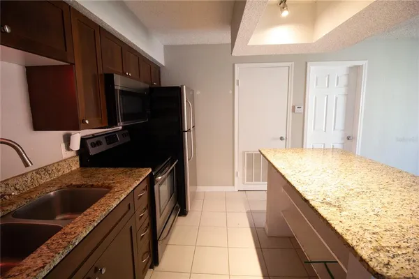 a kitchen with a sink stove and refrigerator