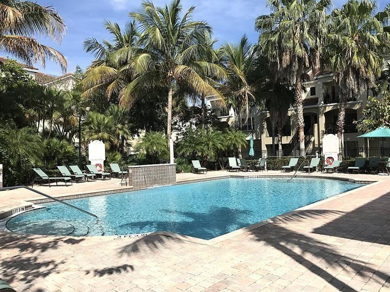 5840 West Sample Road, Unit 103 Coral Springs, FL 33067 - Photo 3 of 9 a view of a yard with palm trees