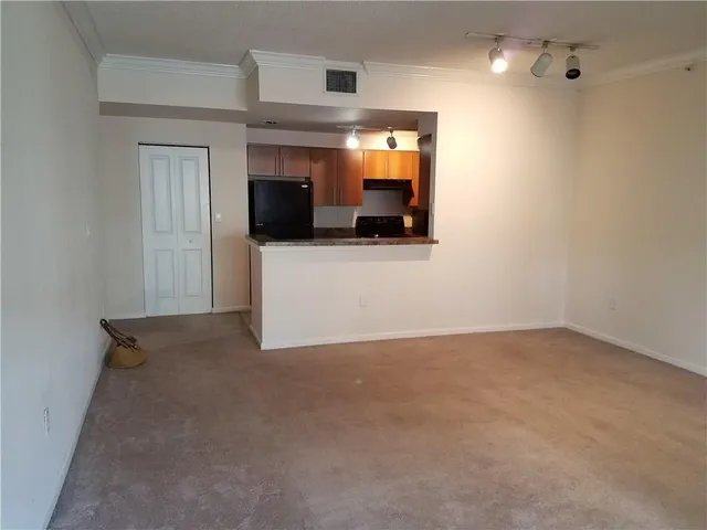 a view of a room with a kitchen