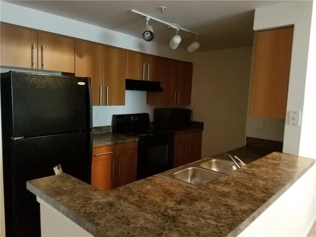 a kitchen with a refrigerator and a sink