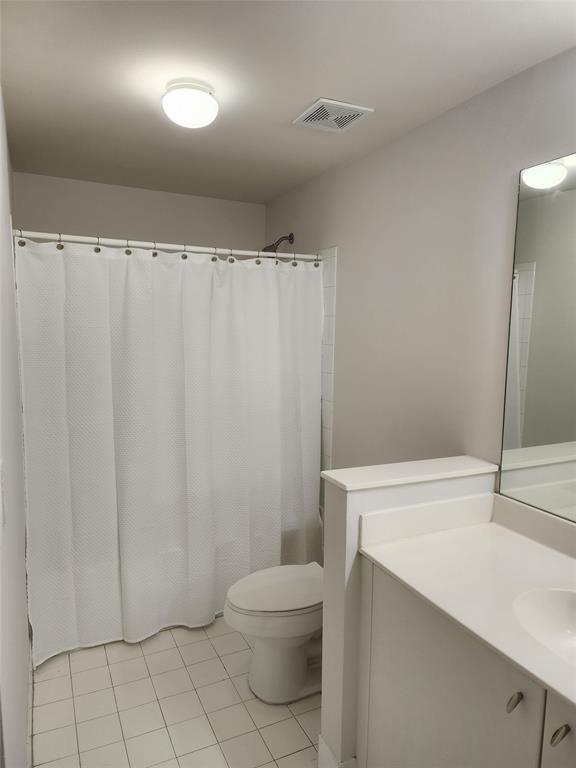 5840 West Sample Road, Unit 103 Coral Springs, FL 33067 - Photo 8 of 9 a bathroom with a toilet a sink and shower