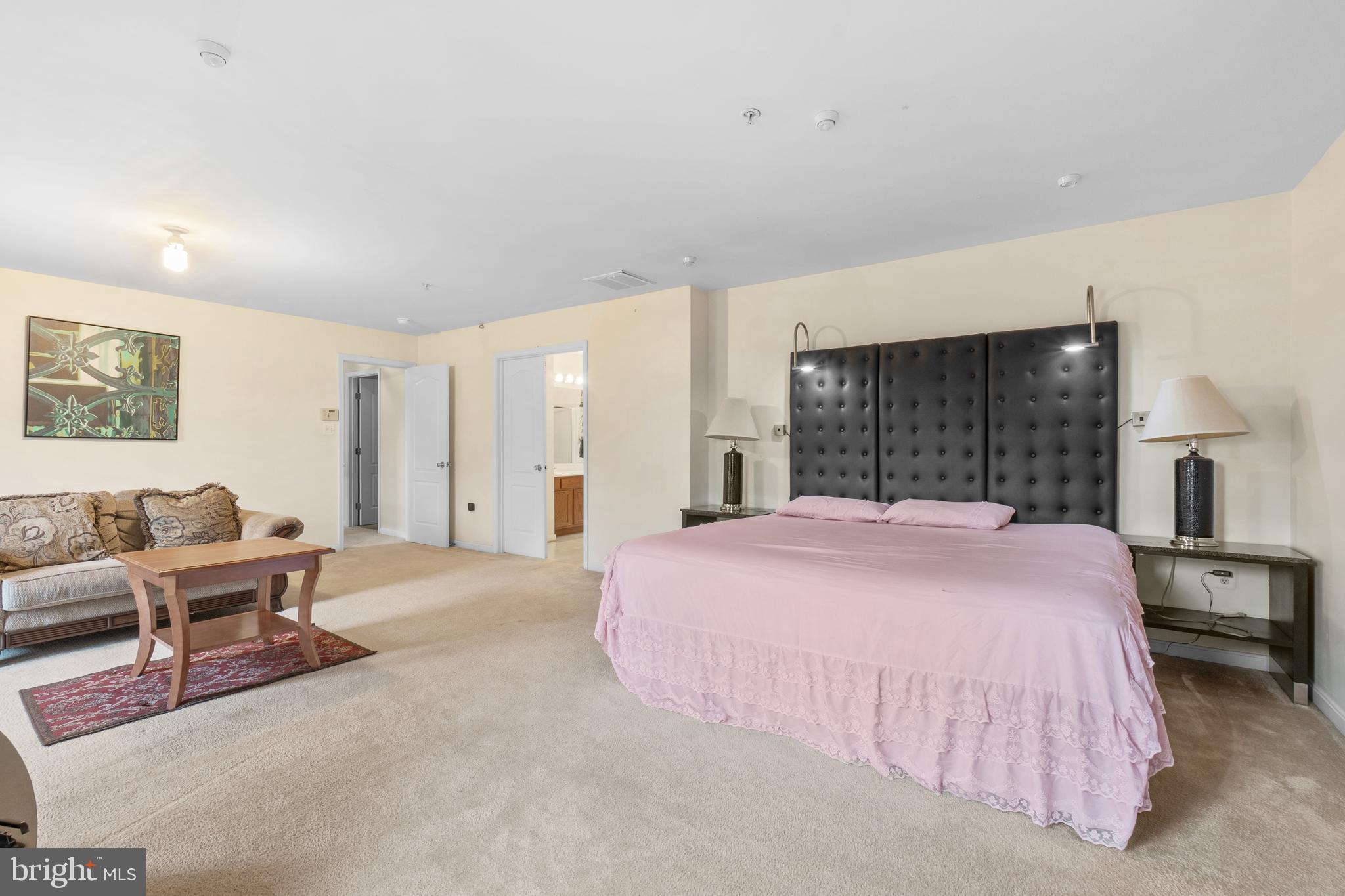 10107 Mike Road Fort Washington, MD 20744 - Photo 14 of 35 a spacious bedroom with a bed a table and chair