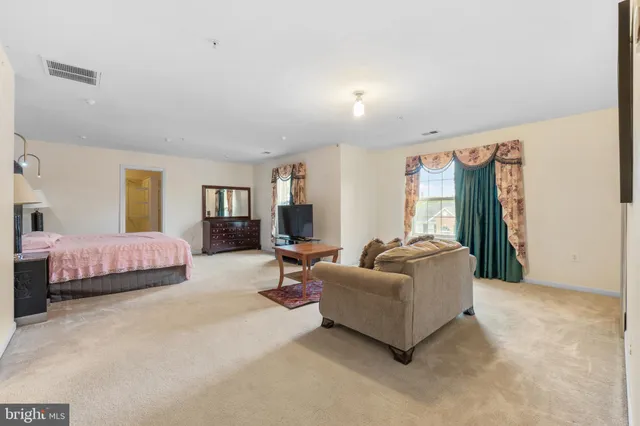 a spacious bedroom with a bed and a couch