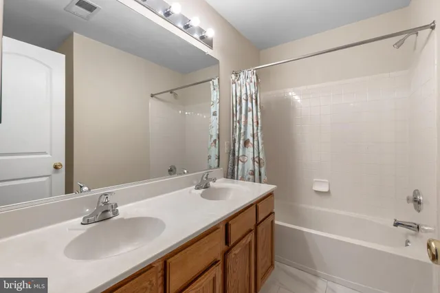 a bathroom with a tub sink and mirror