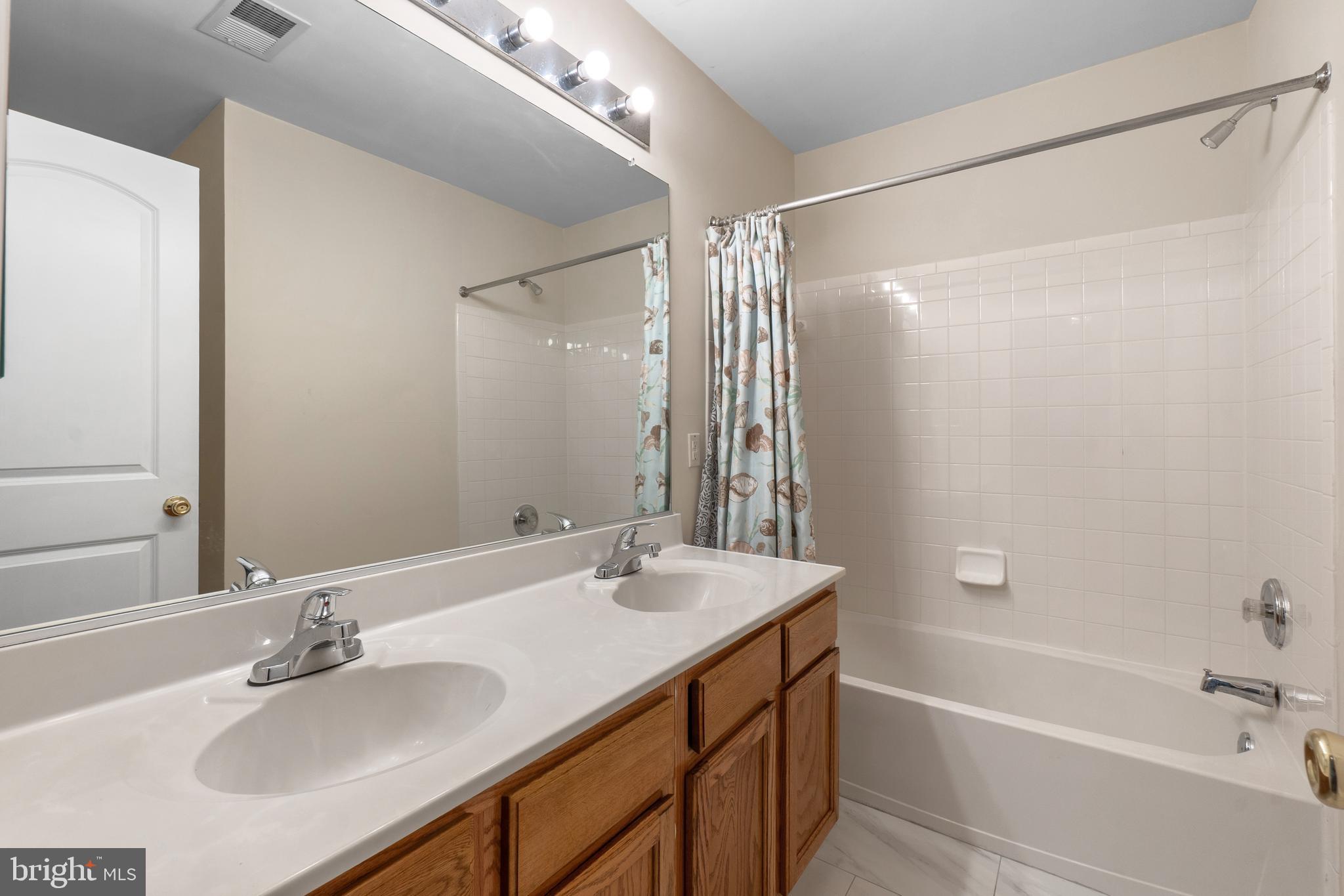 10107 Mike Road Fort Washington, MD 20744 - Photo 25 of 35 a bathroom with a tub sink and mirror