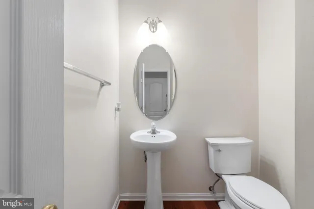 a bathroom with a toilet a sink and a mirror
