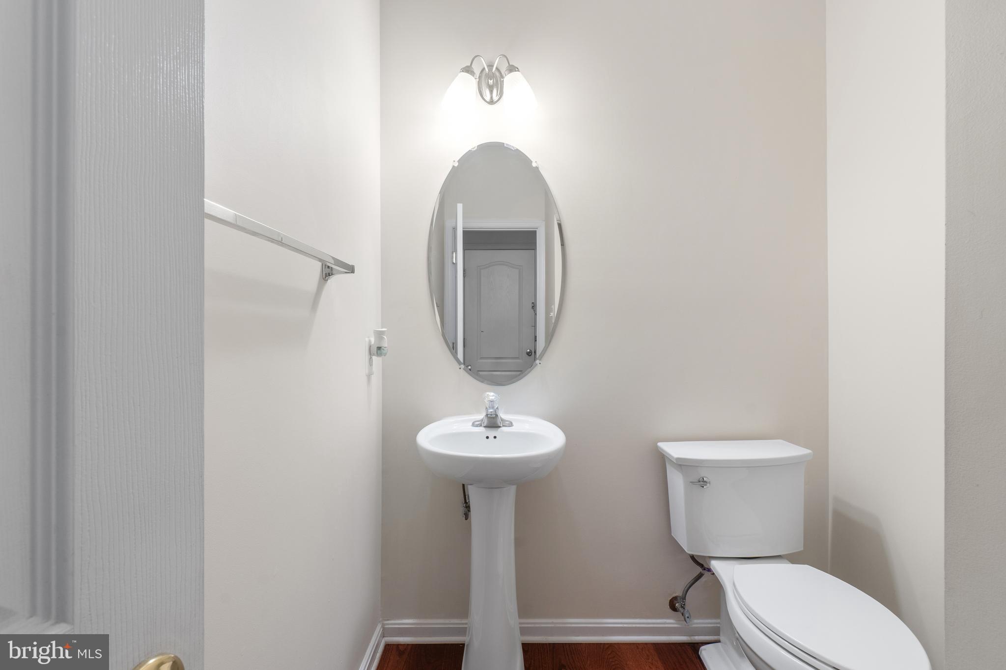 10107 Mike Road Fort Washington, MD 20744 - Photo 29 of 35 a bathroom with a toilet a sink and a mirror