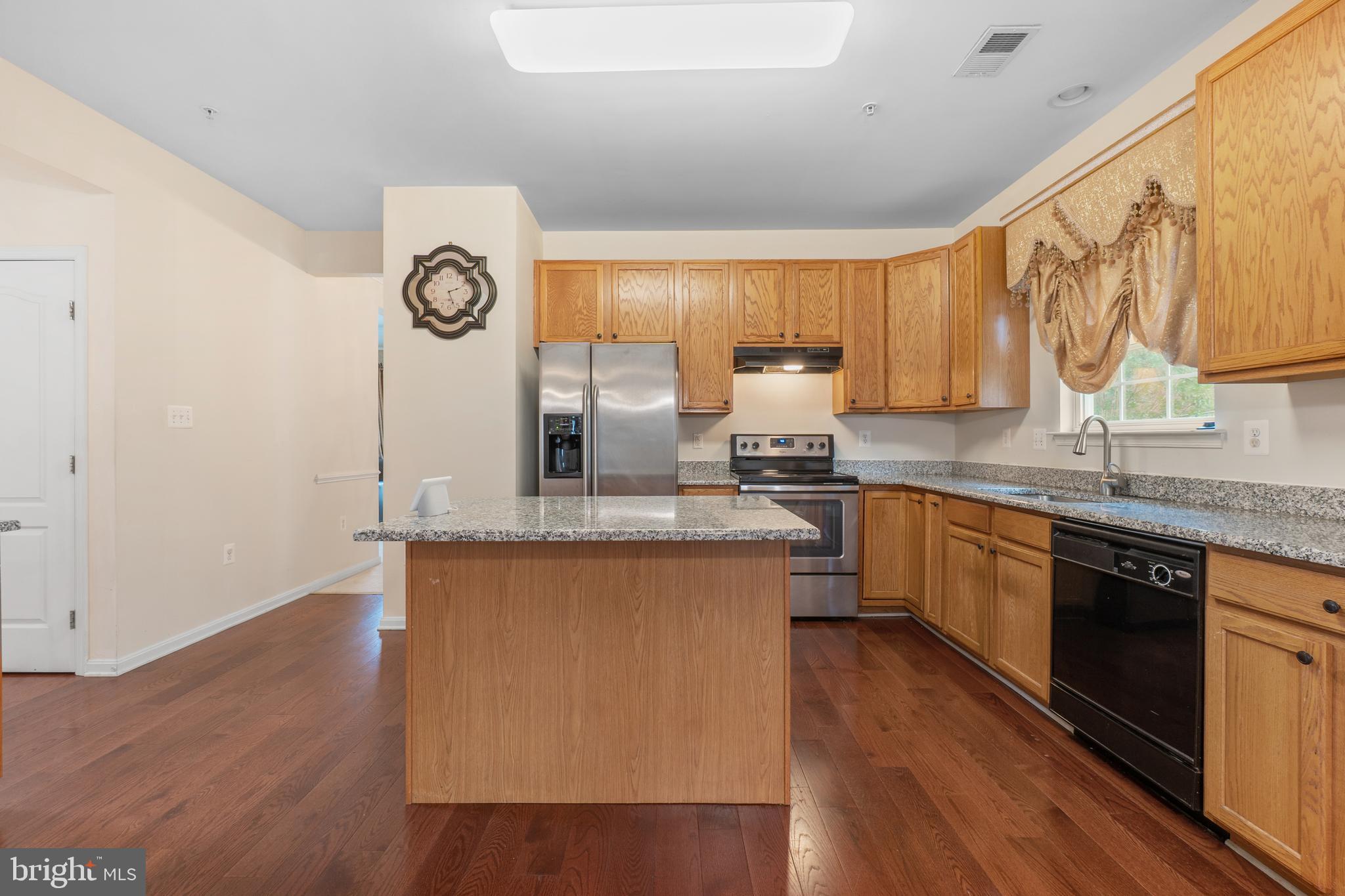 10107 Mike Road Fort Washington, MD 20744 - Photo 3 of 35 a kitchen with granite countertop a sink cabinets and wooden floor