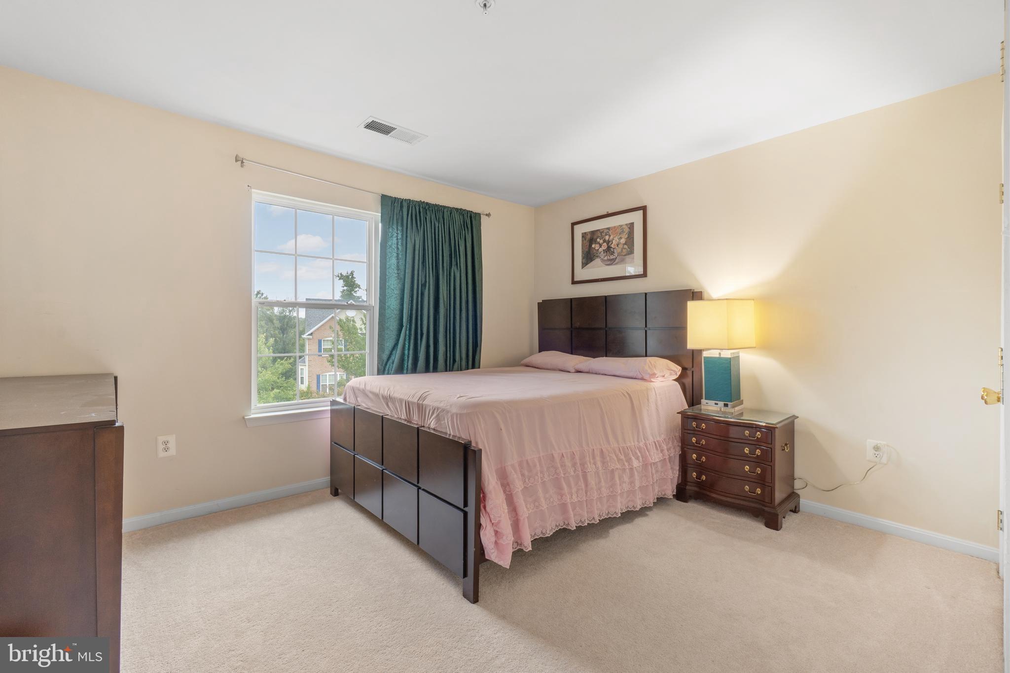 10107 Mike Road Fort Washington, MD 20744 - Photo 31 of 35 a bedroom with a bed lamp and a window