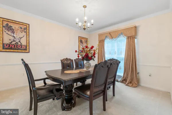 a view of a dining room with furniture and chandelier