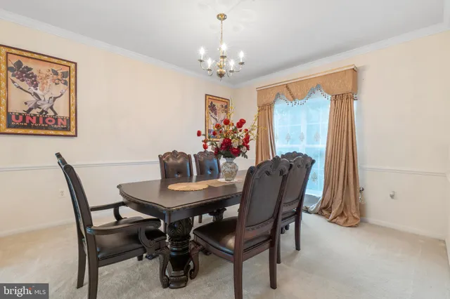 a view of a dining room with furniture and chandelier
