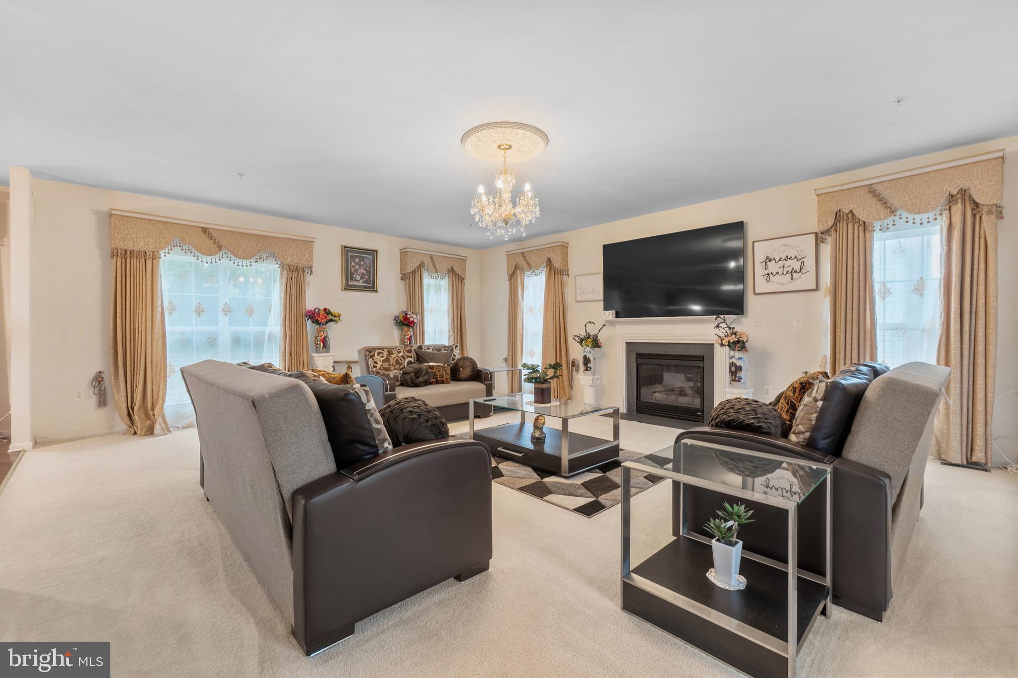 10107 Mike Road Fort Washington, MD 20744 - Photo 7 of 35 a living room with furniture a fireplace and a flat screen tv