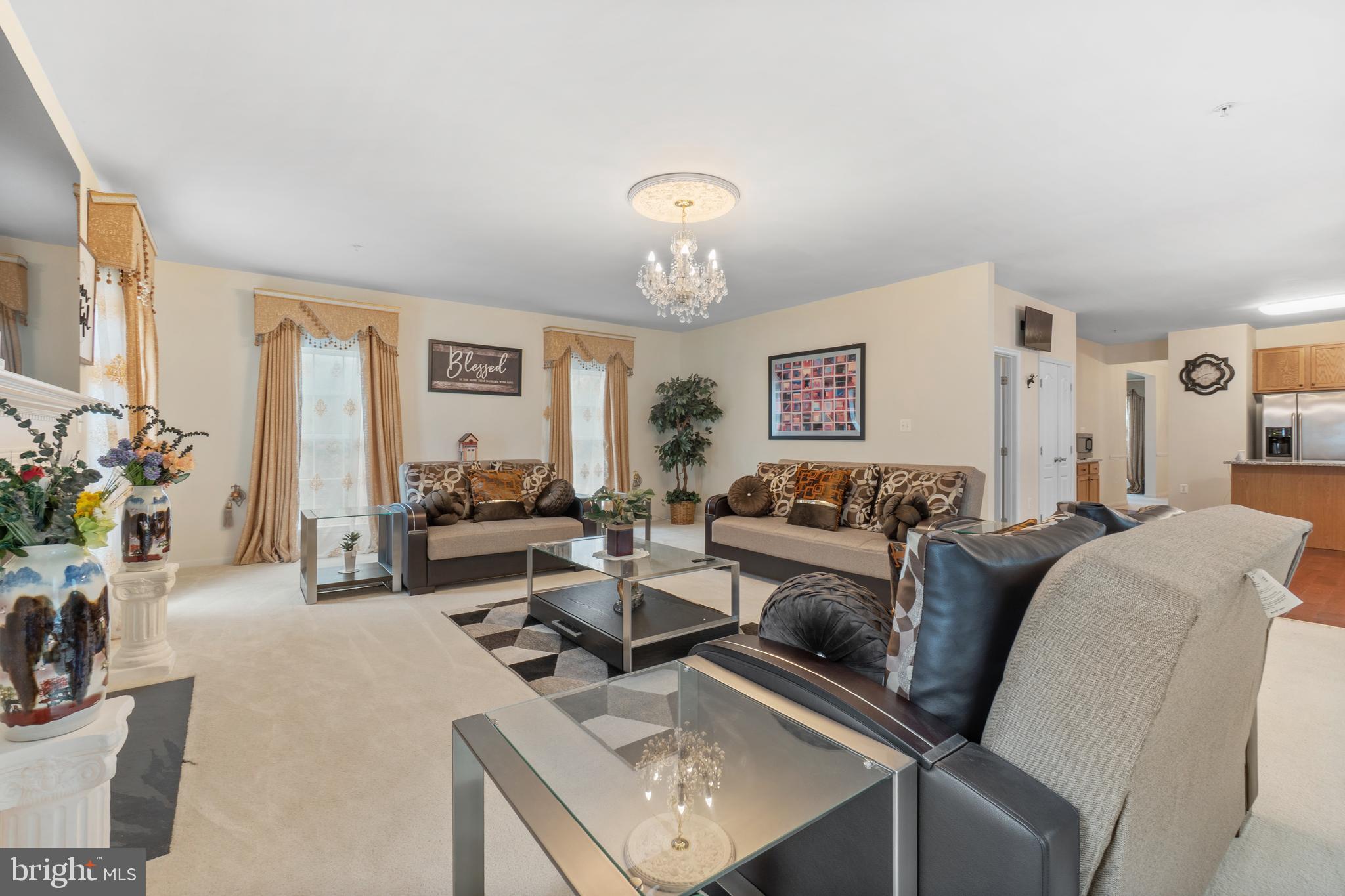 10107 Mike Road Fort Washington, MD 20744 - Photo 9 of 35 a living room with furniture a chandelier and a flat screen tv