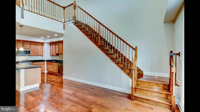a view of staircase with white walls and a window