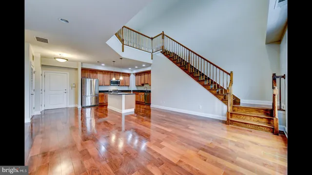 a view of entryway and hall with wooden floor