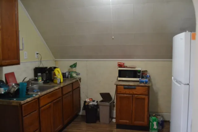 a kitchen with stainless steel appliances a stove a refrigerator a sink and cabinets