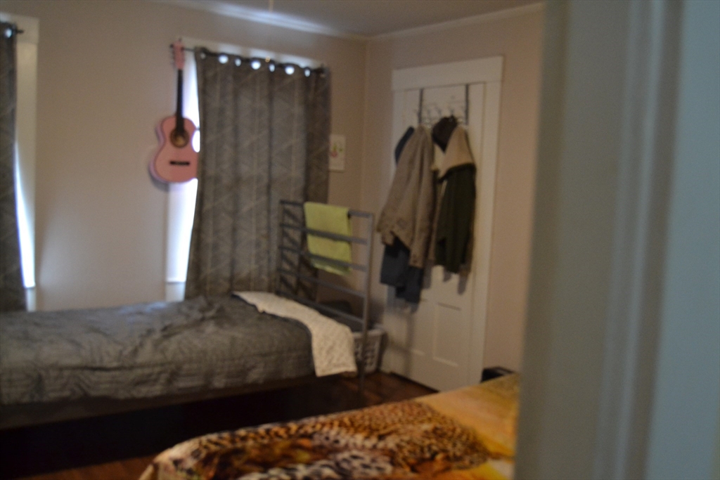 32 Wamesit Street, Unit 3 Lowell, MA 01852 - Photo 3 of 14 a bedroom with a bed and a walk in closet