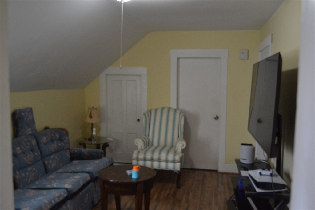 32 Wamesit Street, Unit 3 Lowell, MA 01852 - Photo 6 of 14 a living room with furniture and a wooden floor