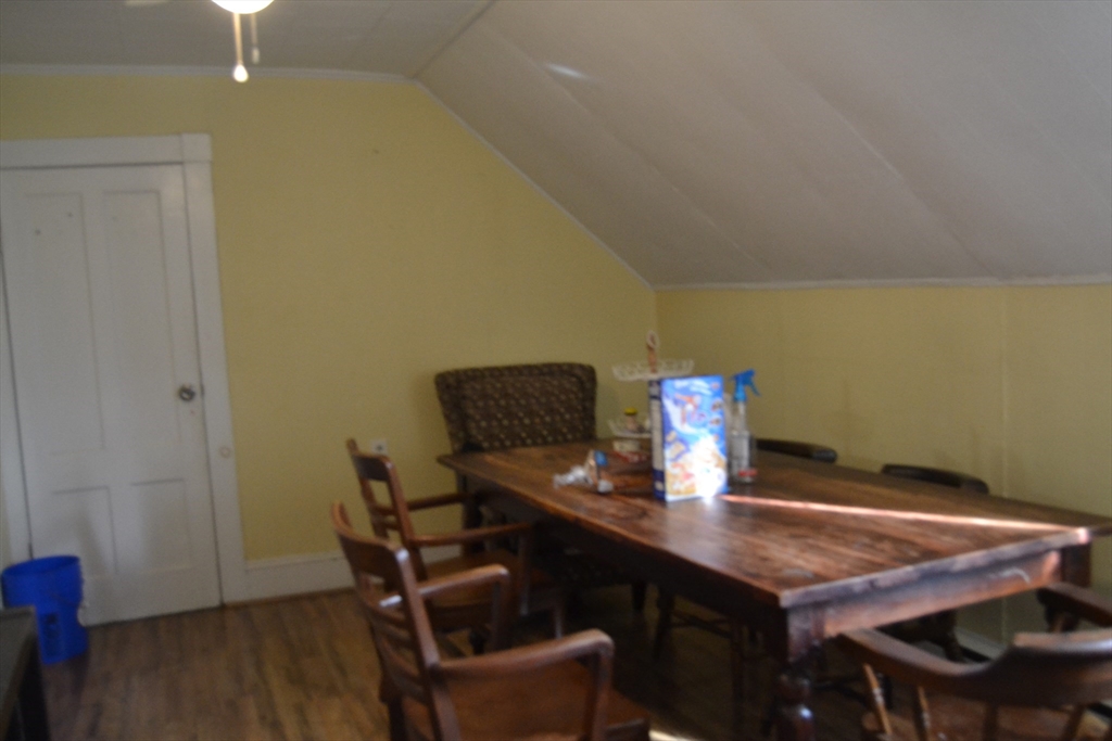 32 Wamesit Street, Unit 3 Lowell, MA 01852 - Photo 7 of 14 a dining room with furniture and wooden floor