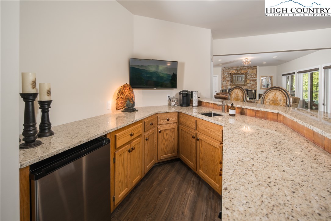 1005 Evergreen Drive Boone, NC 28607 - Photo 26 of 44 a kitchen with granite countertop a sink a stove and cabinets