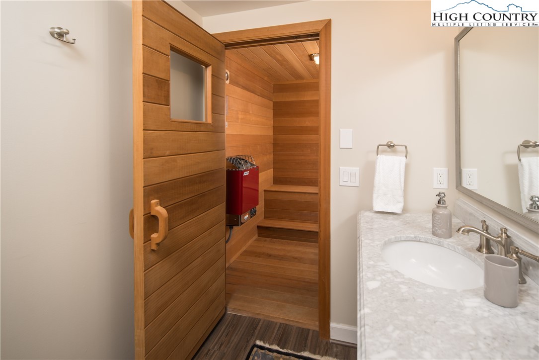 1005 Evergreen Drive Boone, NC 28607 - Photo 28 of 44 a bathroom with a granite countertop sink a mirror and shower