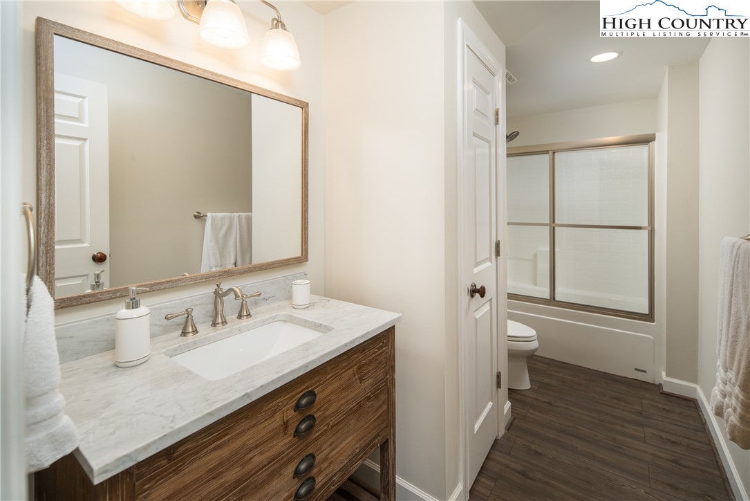 1005 Evergreen Drive Boone, NC 28607 - Photo 31 of 44 a bathroom with a granite countertop sink mirror and a toilet