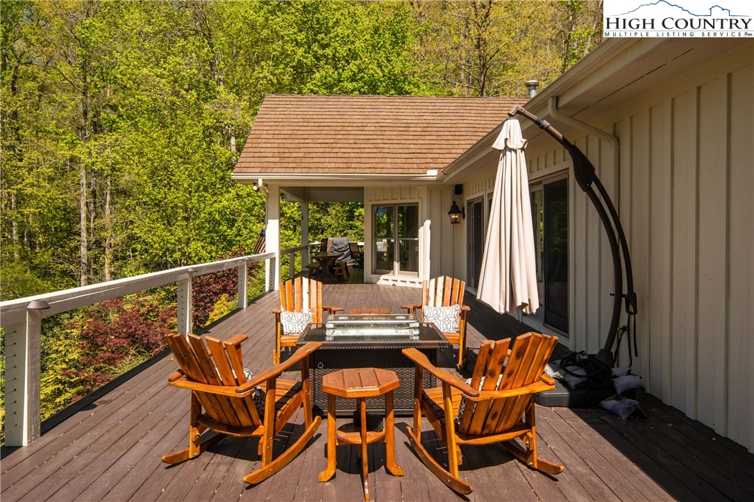 1005 Evergreen Drive Boone, NC 28607 - Photo 36 of 44 a view of a patio with table and chairs with wooden floor and fence