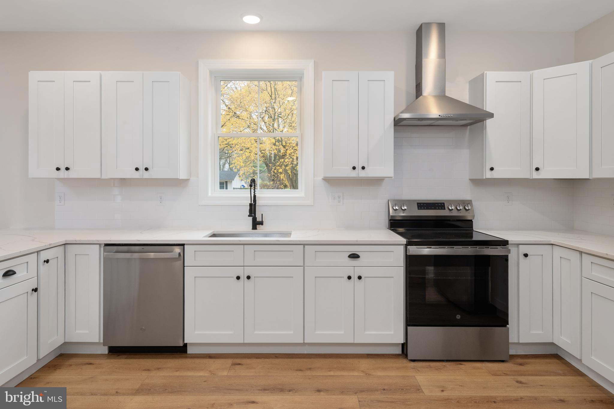 208 Long Point Road Stevensville, MD 21666 - Photo 13 of 52 a kitchen with stainless steel appliances granite countertop a sink and a stove
