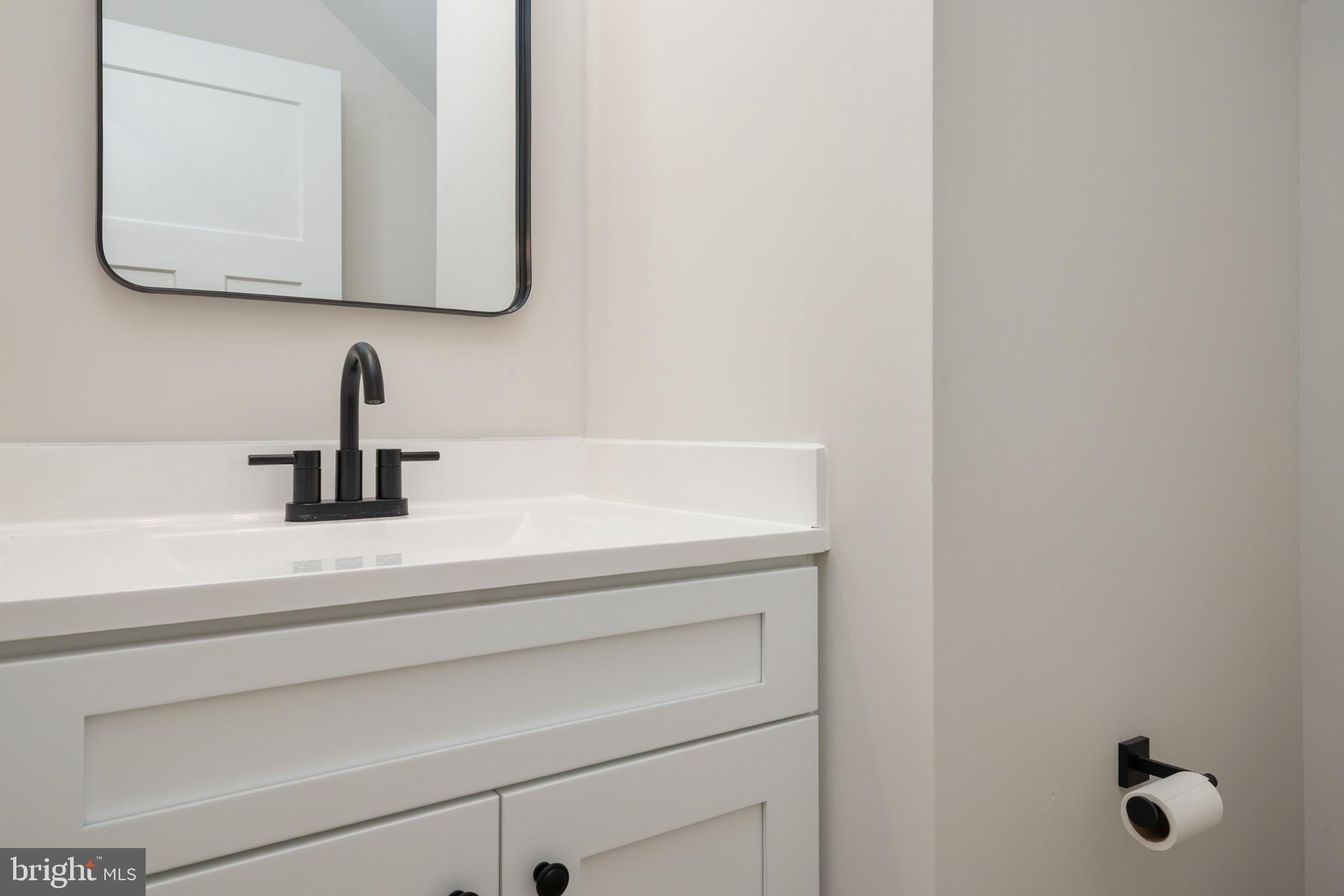 208 Long Point Road Stevensville, MD 21666 - Photo 16 of 52 a bathroom with a sink and a mirror