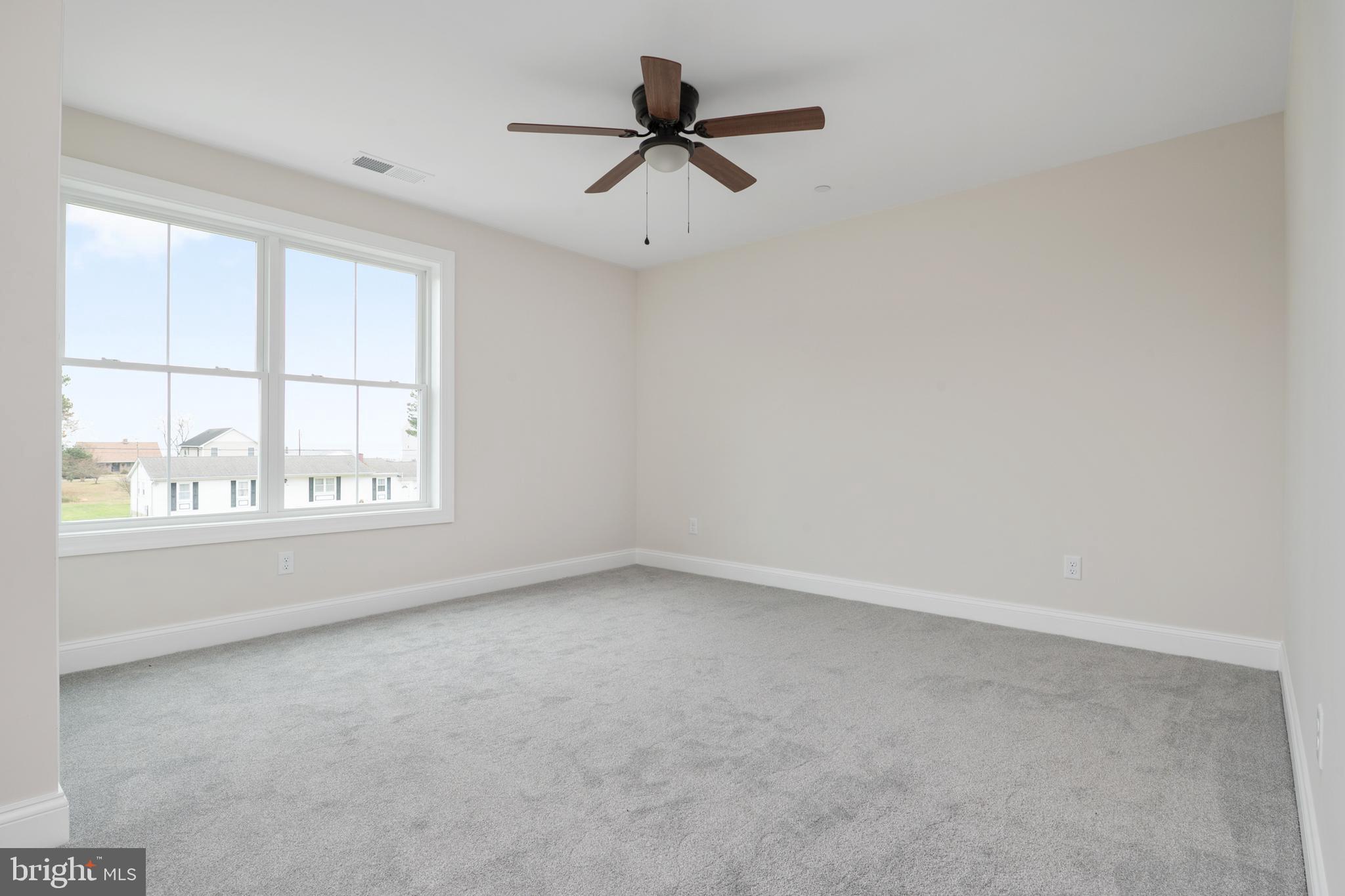 208 Long Point Road Stevensville, MD 21666 - Photo 21 of 52 an empty room with a window and a ceiling fan