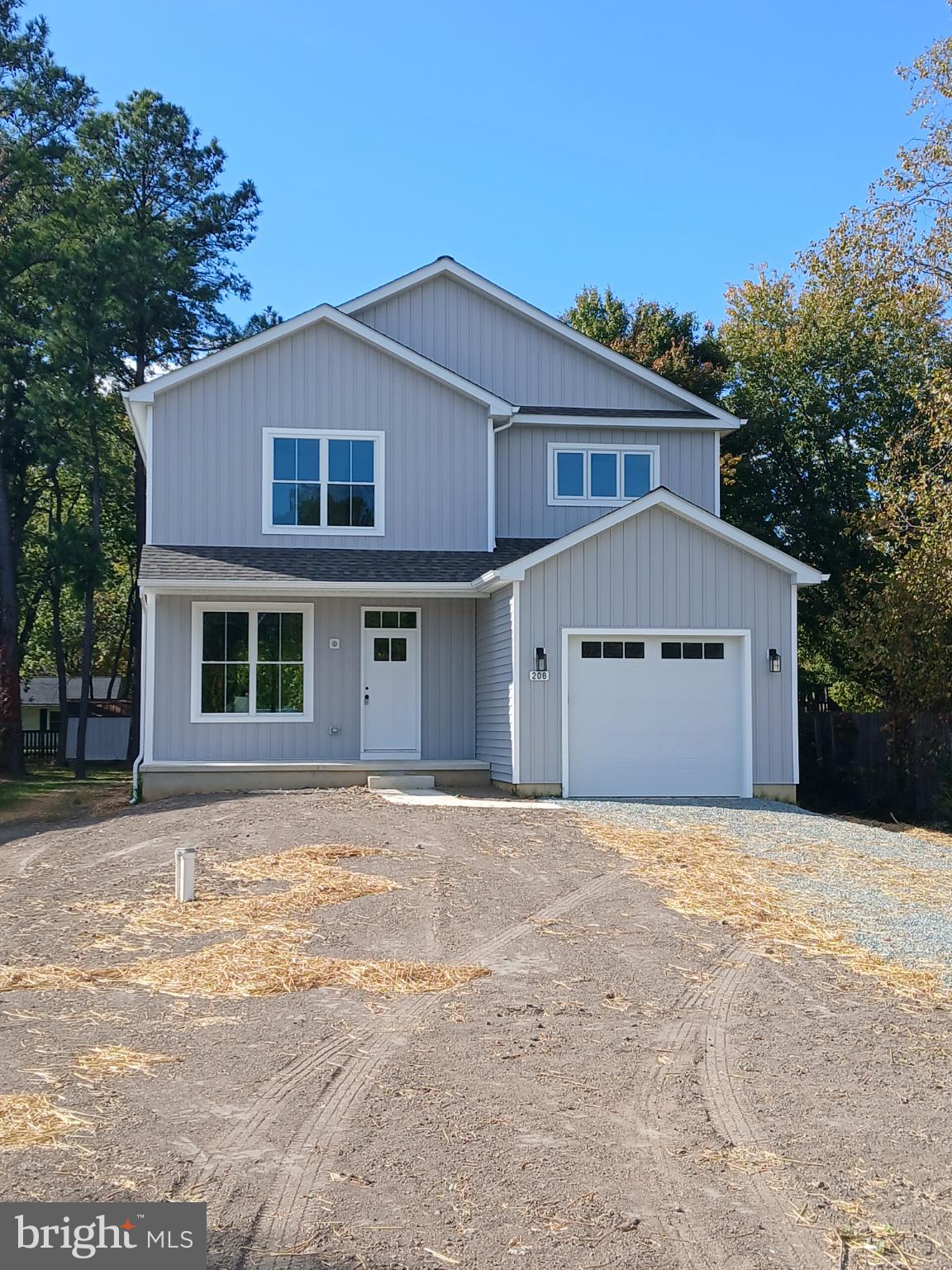 208 Long Point Road Stevensville, MD 21666 - Photo 35 of 52 a front view of a house with a yard and garage