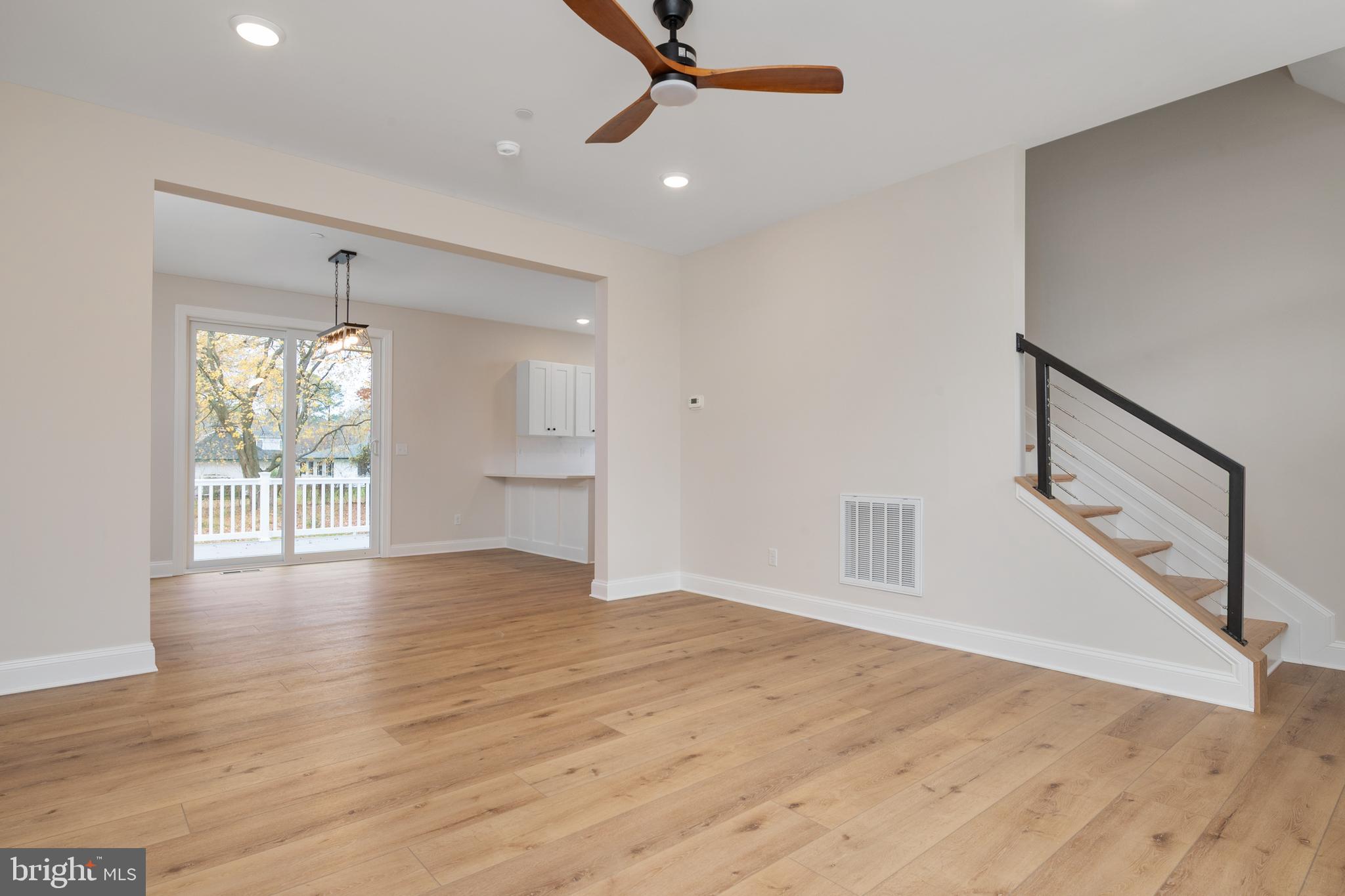 208 Long Point Road Stevensville, MD 21666 - Photo 6 of 52 a view of an empty room with wooden floor and a window