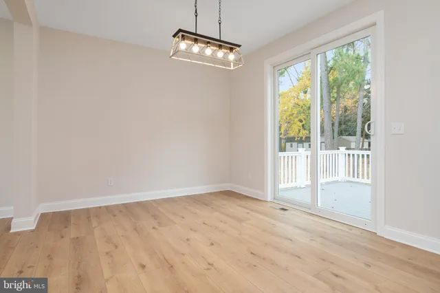a view of deck with wooden floor and trees