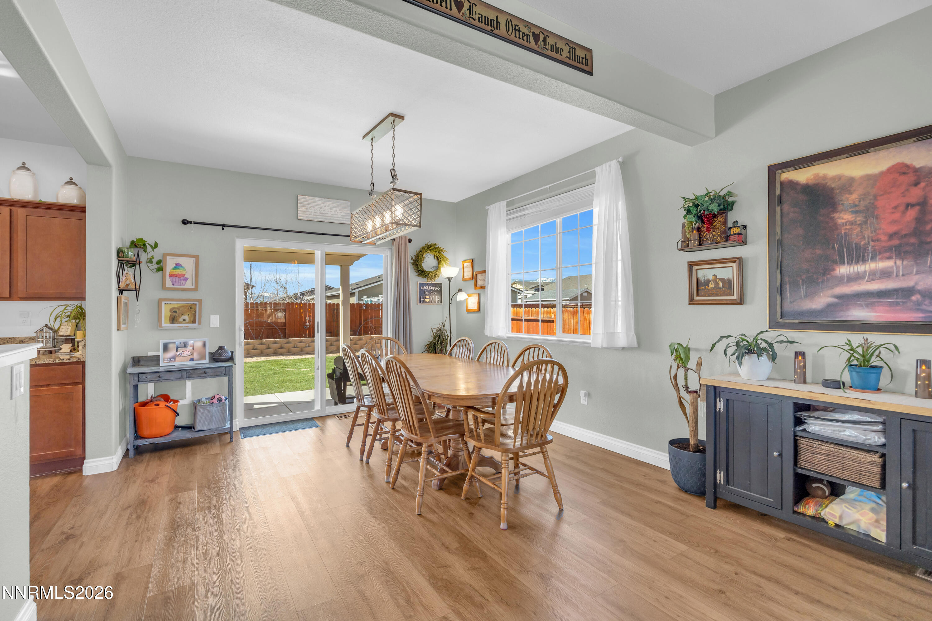 18648 Granite Peak Court Reno, NV 89508 - Photo 12 of 53 a dining room with furniture a flat screen tv and wooden floor