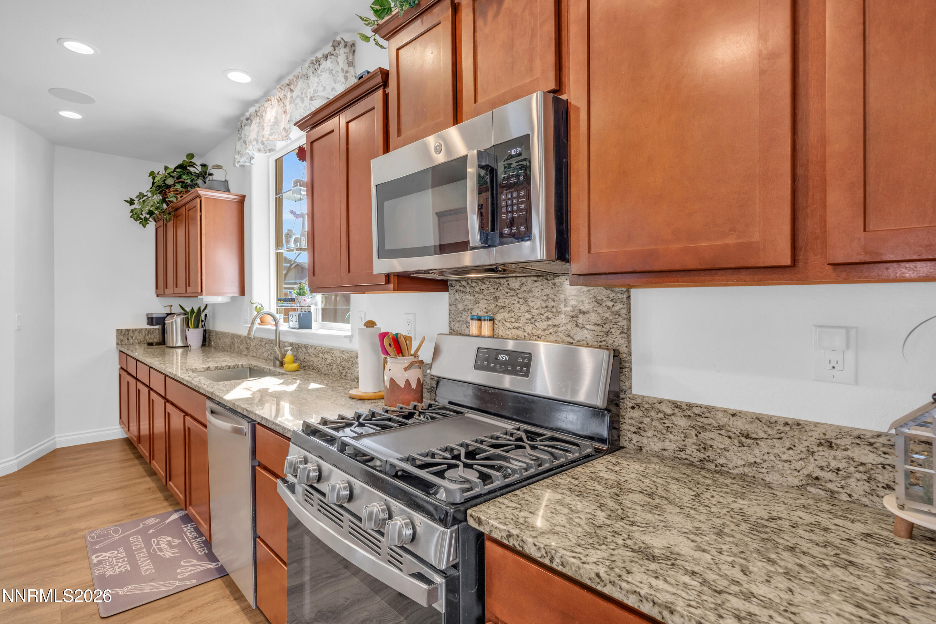 18648 Granite Peak Court Reno, NV 89508 - Photo 14 of 53 a kitchen with a stove and a sink